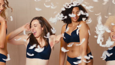 Feathers-Falling-On-Group-Of-Body-Positive-Women-Friends-One-With-Prosthetic-Limb-In-Underwear