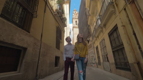 A-smiling-couple-walking-on-a-beautiful-Valencia-street