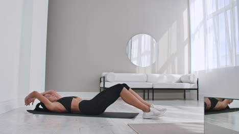 Home-fitness-concept.-Woman-doing-abs-crunches-on-floor-at-home-copy-space