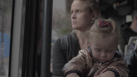 Baby-girl-on-mums-lap-in-the-bus