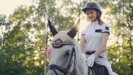 Girl-is-stroking-the-horse-after-walk-in-nature.-Horse-riding-is-an-important-hobby-for-her.