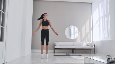 Woman-doing-jumping-jacks-at-home.-Sportswoman-doing-jumping-jacks-exercise-at-home
