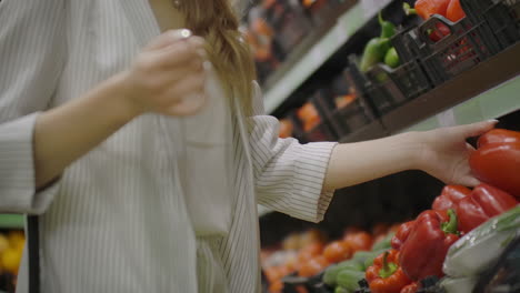 Woman-Buying-red-Pepper-in-Supermarket.-Female-Hand-Choosing-Organic-Vegetables-in-Grocery-Store.-Zero-Waste-Shopping-and-Healthy-Lifestyle-Concept.-Slow-motion