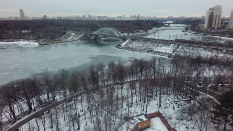 Aerial-winter-shot-of-Moscow-with-river-and-railway-bridge-Russia