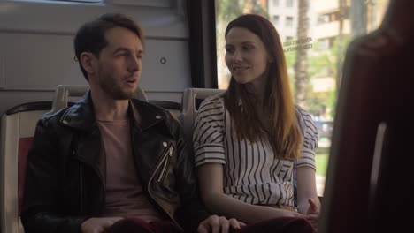 Man-and-woman-talking-in-the-bus
