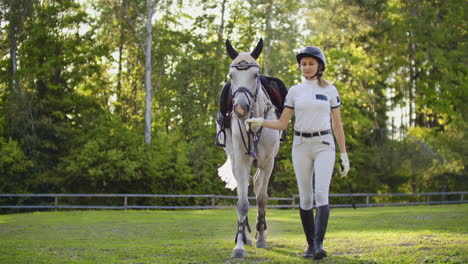 Female-with-her-horse-walking-in-nature-before-professional-training-in-the-horse-club.-Great-hobby-for-amazing-life.