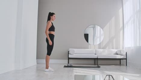 Beautiful-Fit-Girl-Doing-Home-Workout-Performing-Lateral-Lunges-In-A-Sitting-Room