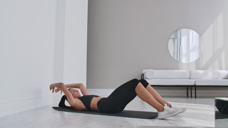 Home-fitness-concept.-Woman-doing-abs-crunches-on-floor-at-home-copy-space