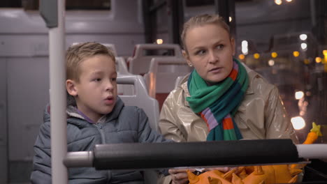 Mum-and-son-talking-when-traveling-by-bus-in-the-evening