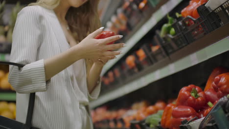 Hands-take-few-colorful-pepper-one-by-one-in-marketplace-and-hold.-Close-up-concept-of-selection-buy-quality-fruit-or-red-vegetables.-Young-woman-pick-up-some-tasty-freshness-ingredient-for-cooking