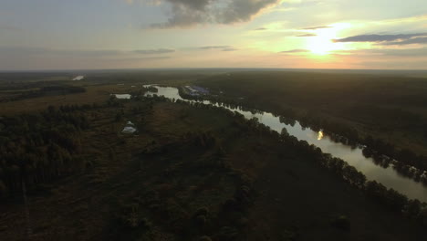 Aerial-green-landscape-with-river-at-sunset
