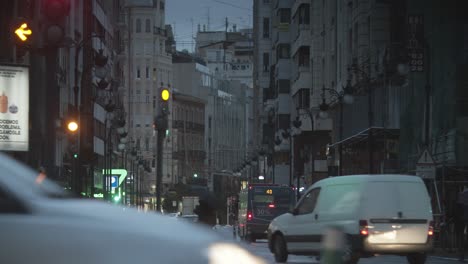 Street-view-with-traffic-in-rainy-evening-Valencia-Spain