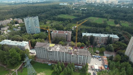 Aerial-view-of-apartment-house-under-construction-and-summer-Moscow-cityscape