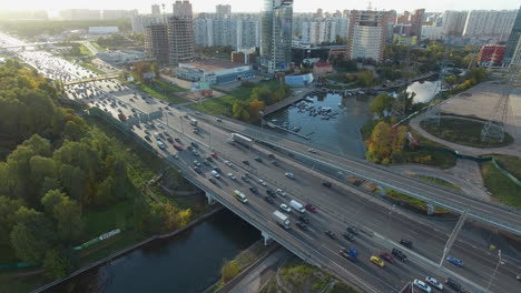 An-aerial-view-of-a-busy-highway-above-the-river-in-the-middle-of-the-city