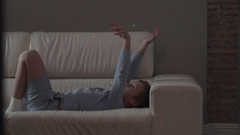 Playful-child-wants-to-catch-laser-dots-of-Christmas-illumination