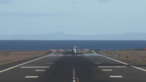 Airliner-taking-off-Scenic-runway-overlooking-sea-and-mountains