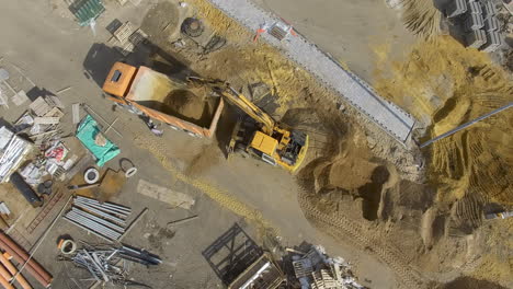 Loading-truck-with-sand-on-construction-site-aerial