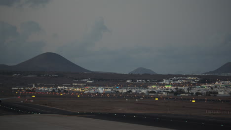 A-plane-taking-off-the-runway-against-the-evening-mountains