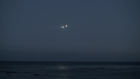Plane-coming-in-for-a-landing-over-the-ocean-evening-view