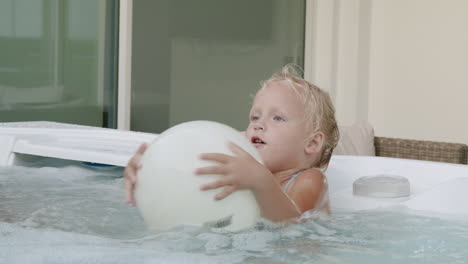 Little-girl-enjoying-fun-day-with-family-bathing-in-hot-tub