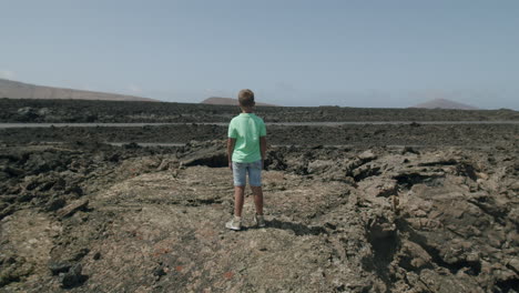 Child-exploring-lifeless-but-picturesque-Lanzarote-landscape