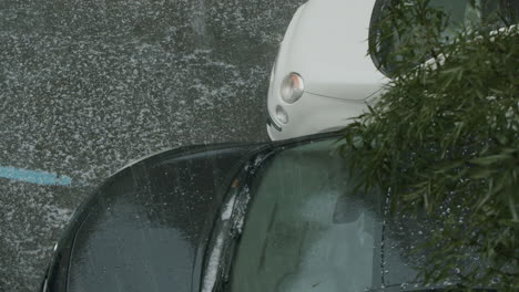 A-car-flashing-its-headlights-during-a-hailstorm