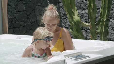 Mother-and-little-daughter-relaxing-and-having-fun-in-spa-bath