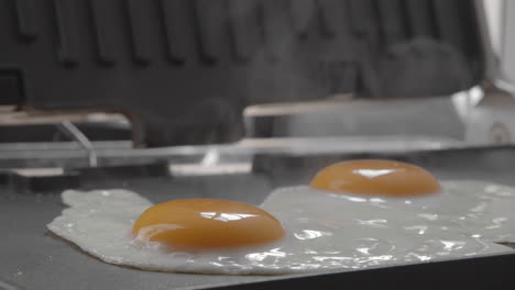 Sunny-side-up-eggs-for-breakfast-cooked-on-electric-grill