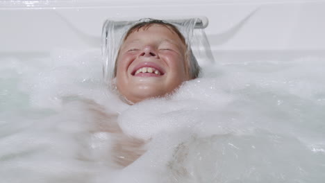 Hydromassage-is-so-exciting-Child-having-fun-in-spa-tub