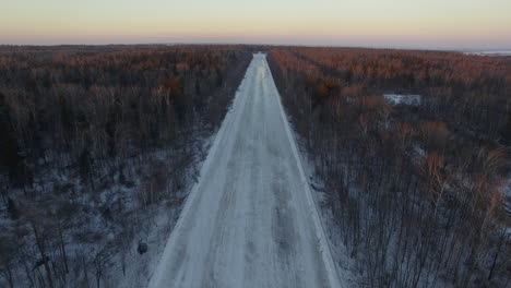 Aerial-view-of-empty-road-in-winter-woods