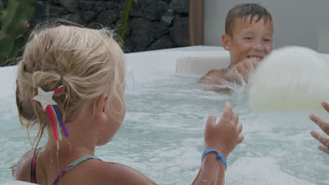 Day-is-full-of-fun-Brother-with-little-sister-playing-ball-in-hot-tub