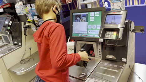 Boy-helps-mum-to-buy-food-in-the-self-service-supermarket