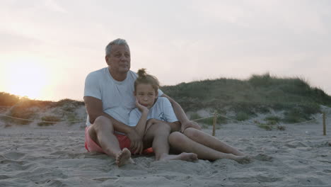 Grandpa-and-grandson-on-the-beach-at-sunset