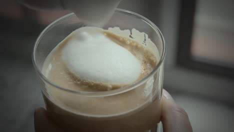 Fresh-made-latte-being-finished-with-milk-foam