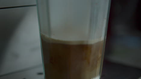 Coffee-machine-processing-latte-close-up