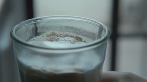 Barista-making-latte-and-finishing-it-with-milk-foam