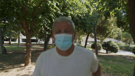 Mature-man-running-in-park-with-face-mask