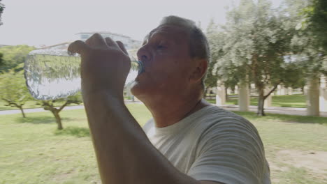 Happy-sportsman-drinking-mineral-water