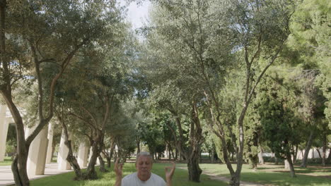 Elderly-man-practicing-yoga-in-the-park