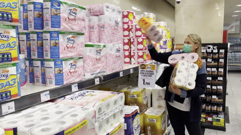 Female-in-mask-buying-toilet-paper-during-epidemic