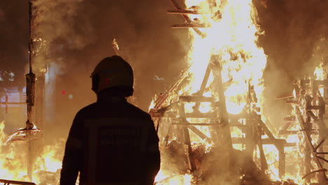 Feuerwehrmann-Steuert-Das-Lagerfeuer-Des-Las-Fallas-Festivals-In-Spanien