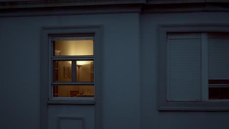 House-window-with-dim-light-in-the-dusk