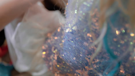 Hand-touching-sparkling-paillette-dress