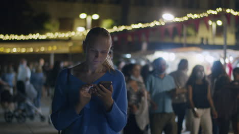 Woman-chatting-on-mobile-during-night-city-walk