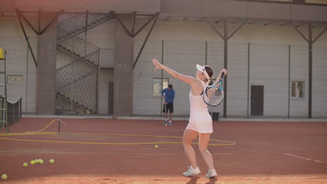 Tennis-game-on-sunny-day-at-tennis-court-young-sportive-woman-playing.