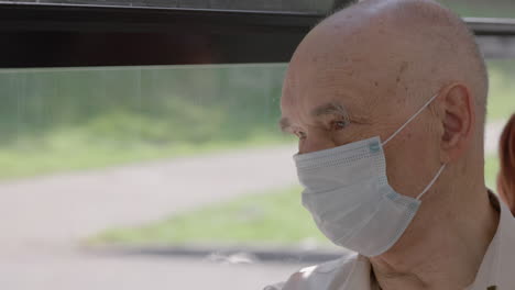 Senior-man-in-medical-mask-is-on-a-bus