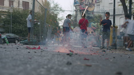 Kids-celebrating-Fallas-festival-and-launching-firecrackers-in-city-street
