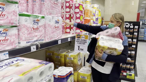 Female-in-mask-buying-toilet-paper-during-epidemic