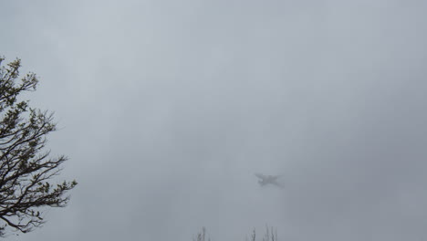 Airplane-vanishing-in-overcast-sky