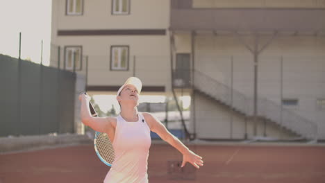Tennis-serve---woman-tennis-player-serving-playing.-Tennis-outside-in-summer.-Fit-female-athlete-practicing.-Healthy-active-sport-lifestyle